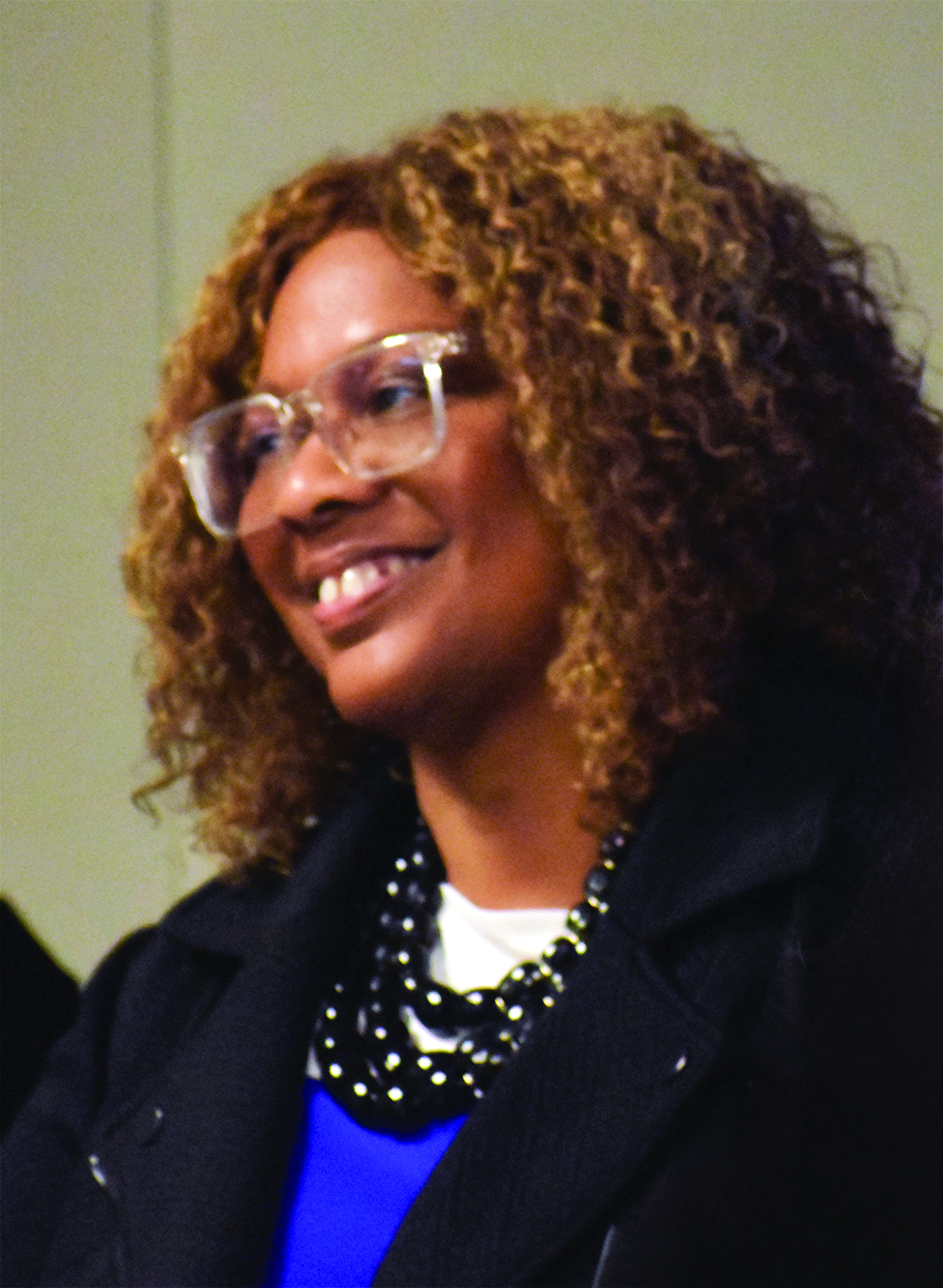 A woman with glasses wearing all black with glasses.