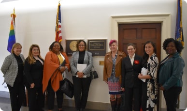 A group of women standing in front of a door.