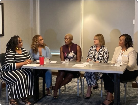 Women sitting together in a conference room for a meeting.